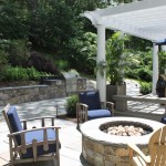 Outdoor kitchen, fire pit design with bluestone terrace.
